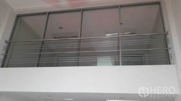 Office Space for rent in Bueng Kum, Bangkok - Mezzanine level with stainless railing and large glass panels under ceiling lights.