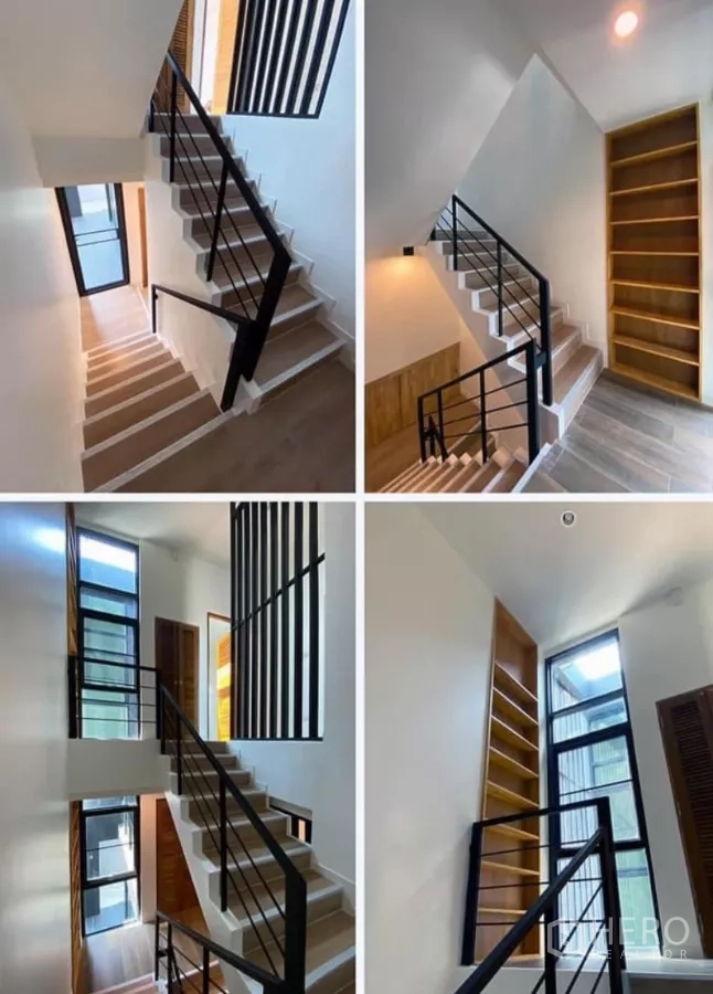 Detached House for rent in Huai Khwang, Bangkok - Central staircase with black metal handrails, large windows and tall built‑in shelves.