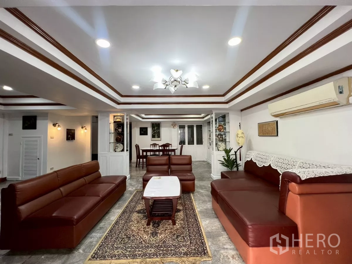 Home Office for rent in Watthana, Bangkok - Open-plan lounge and dining area with built-in shelving and coffered ceiling.