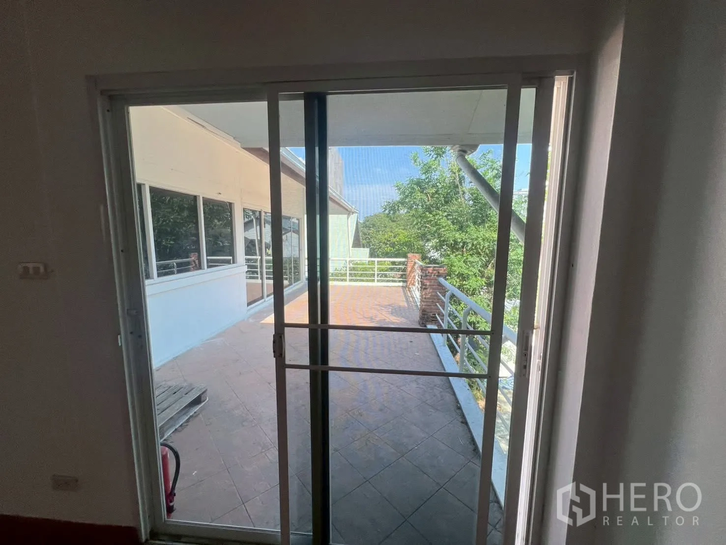 Detached House for rent in Watthana, Bangkok - Sliding door opening to an expansive balcony with railing and treetop views.