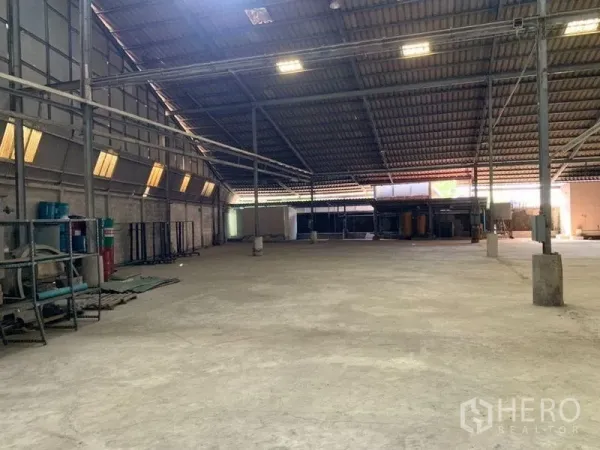 Warehouse for rent - Expansive clear-span warehouse with concrete floor and steel columns.