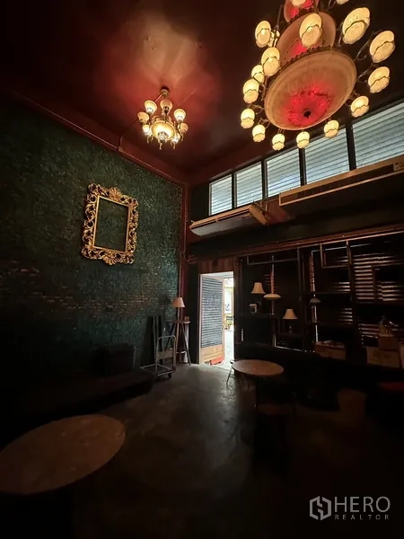 พื้นที่ขายปลีก ให้เช่า - โถงเพดานสูงพร้อมโคมระย้า กรอบรูปลายทอง และชั้นวางใกล้ประตูทางเข้า