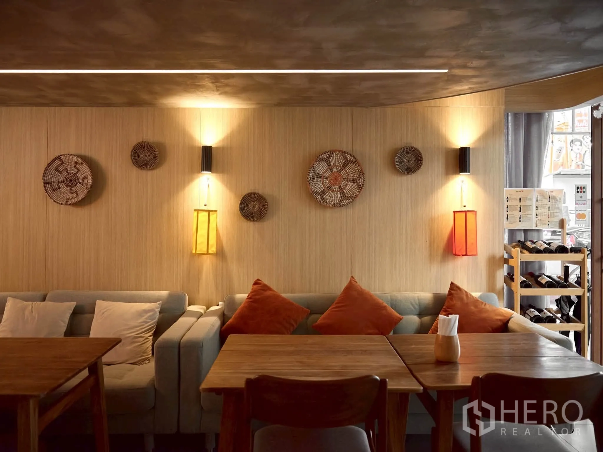 Retail Space for rent in Watthana, Bangkok - Lounge seating with wall sconces and decorative art on wood paneling.