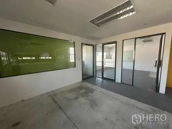 Warehouse for rent in Saphan Sung, Bangkok - Glass-partitioned meeting rooms and green glass board inside office area.