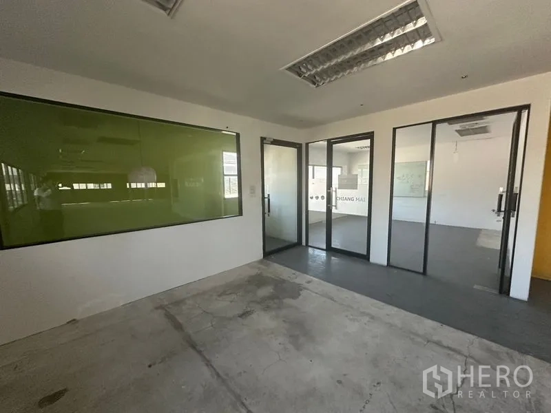 Warehouse for rent in Saphan Sung, Bangkok - Glass-partitioned meeting rooms and green glass board inside office area.