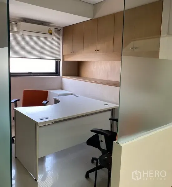 办公空间 出租在Din Daeng, Bangkok - 玻璃隔间内的独立办公室，白色L型桌、百叶窗和木质吊柜