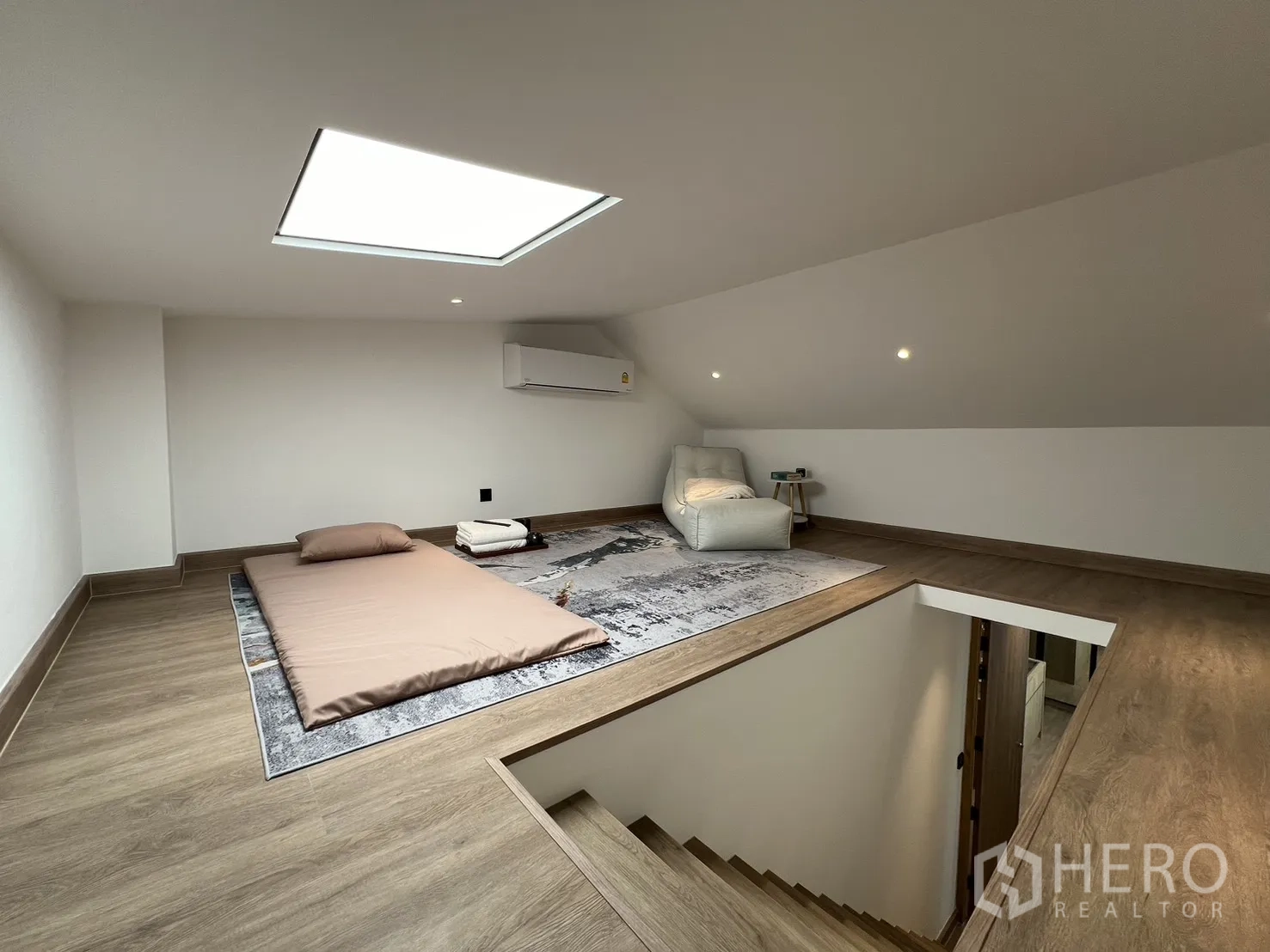 Townhouse for sale in Watthana, Bangkok - Bright bedroom with desk and balcony window screened by sheer curtains.