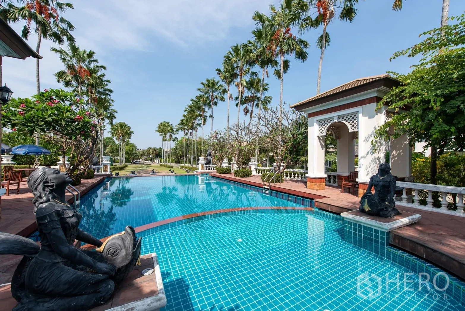 Detached House for sale in Bang Phli, Samut Prakan - Resort-style communal swimming pool with statues, pavilion and palm trees.