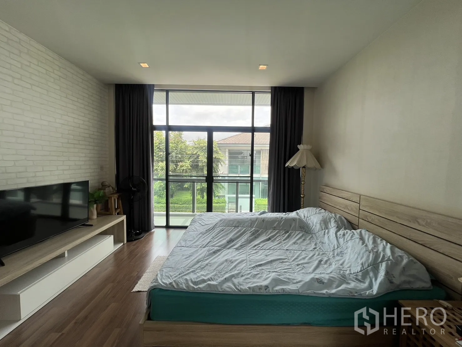Detached House for rent in Bang Kapi, Bangkok - Master bedroom showing bed and blackout curtains across window wall.