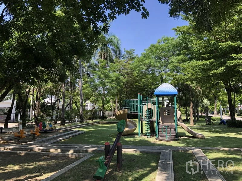 Detached House for rent in Saphan Sung, Bangkok - Shaded community park with children’s playground equipment and green lawns.