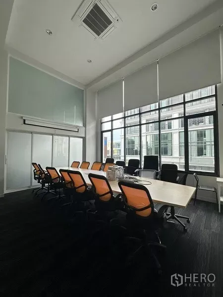 Home Office for rent - Conference room from another angle with roller blinds and sliding glass doors.