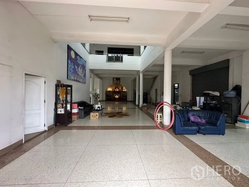 Home Office for sale in Phra Pradaeng, Samut Prakan - Large open-plan ground-floor lobby with columns and tiled floor.