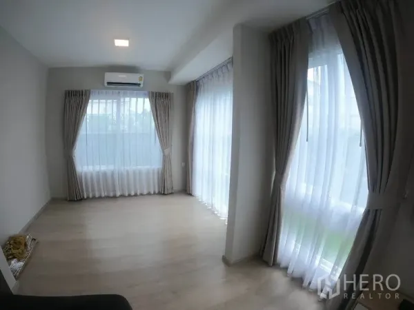 Detached House for rent in Prawet, Bangkok - Sunlit multi-purpose corner room with floor-to-ceiling windows and sheer curtains.