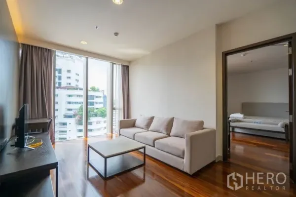 คอนโด ให้เช่าในKhlong Toei, Bangkok - ห้องนั่งเล่นย่อยพร้อมโซฟา ทีวี และหน้าต่างสูง เชื่อมต่อห้องนอนข้างเคียง