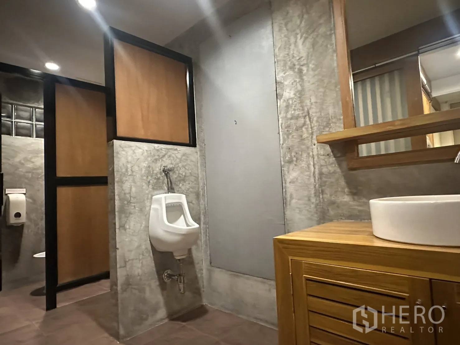 Retail Space for rent in Watthana, Bangkok - Restroom with concrete finish, urinal, vanity with vessel sink, and stall partitions.