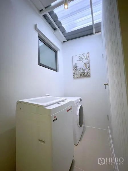 Townhouse for rent in Bang Phli, Samut Prakan - Corner master bedroom with large window overlooking greenery.