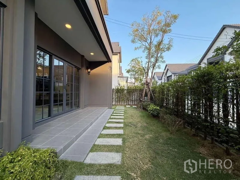 Detached House for rent in Bang Phli, Samut Prakan - Shaded patio and private side garden with stepping stones and hedge.