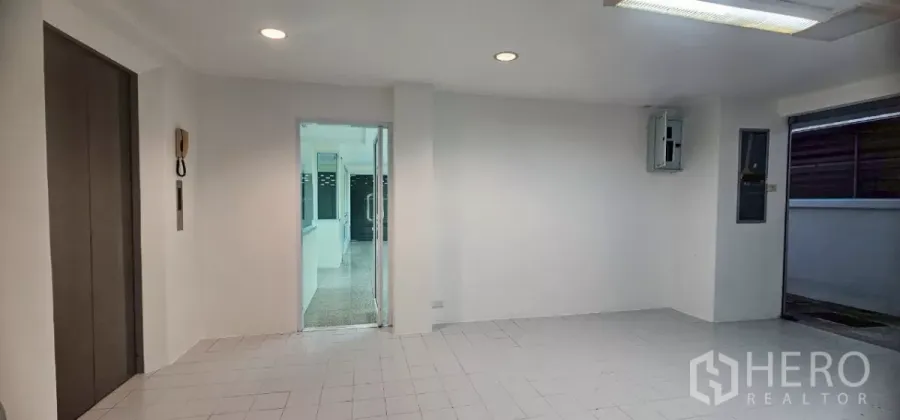 Office Space for rent in Bueng Kum, Bangkok - Lift lobby with recessed lighting and a glass door to the office area.