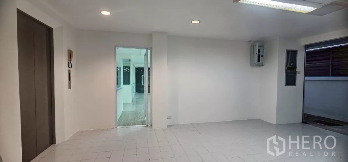 Office Space for rent in Bueng Kum, Bangkok - Lift lobby with recessed lighting and a glass door to the office area.