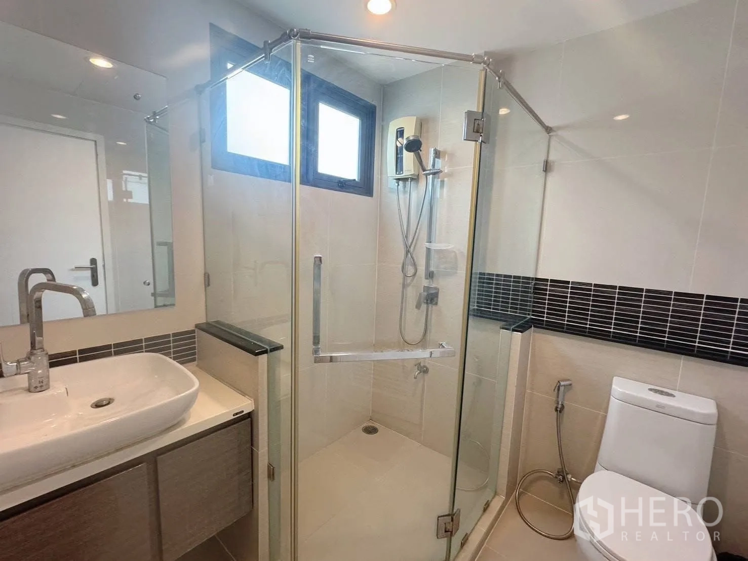 Detached House for rent or sale in Suan Luang, Bangkok - Bathroom with glass-enclosed shower, vanity and toilet.