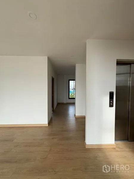 Home Office for rent in Pak Kret, Nonthaburi - Upper-floor corridor with elevator and a window at the end