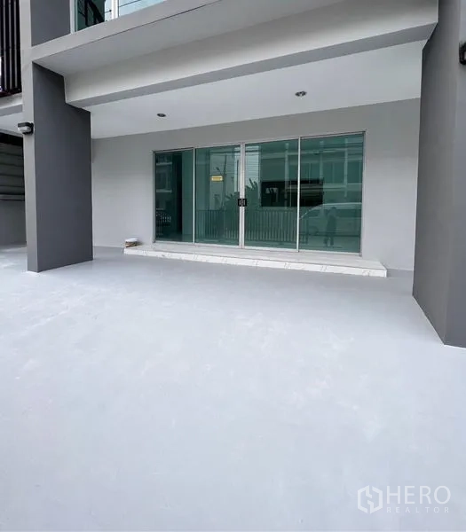 Home Office for sale in Lat Krabang, Bangkok - Ground-floor terrace with wide sliding glass doors under a covered porch.