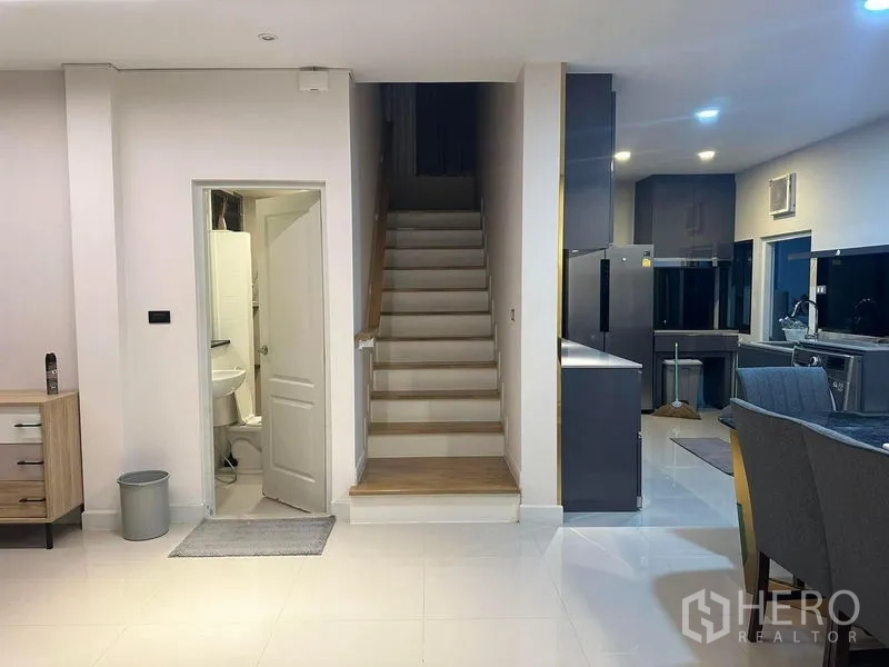 Detached House for rent in Bang Phli, Samut Prakan - Staircase to upper floor beside guest washroom and kitchen zone.
