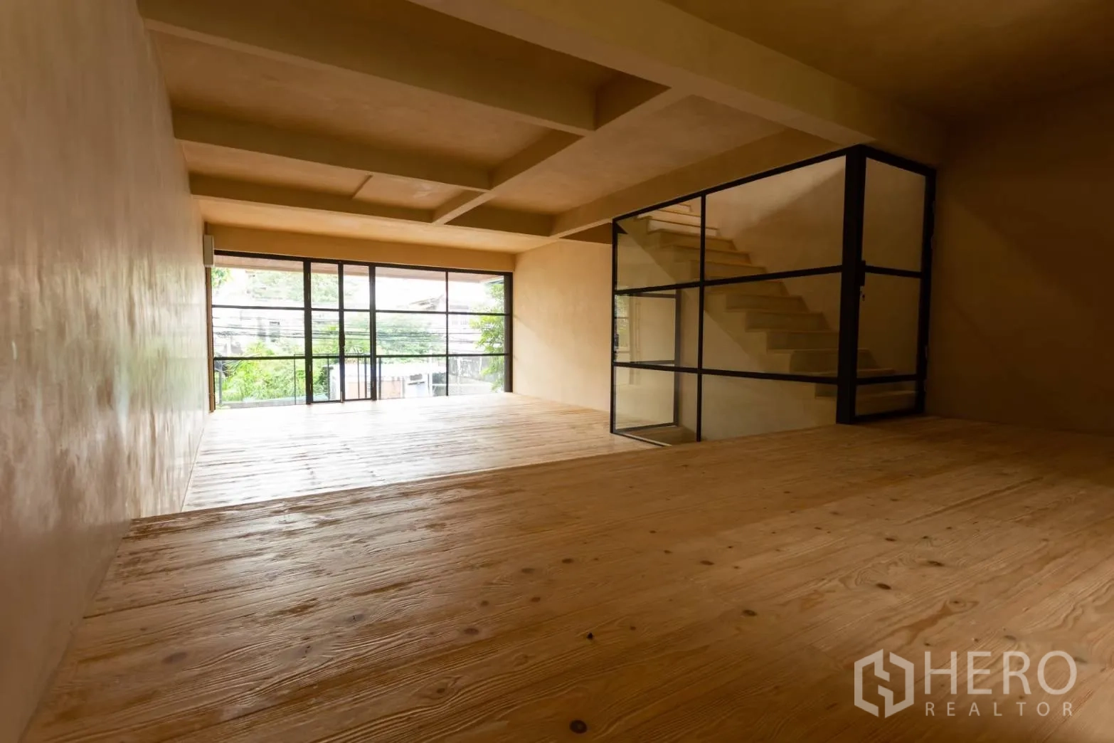 Home Office for rent in Watthana, Bangkok - Bright office level with glass‑enclosed staircase and full-height windows.