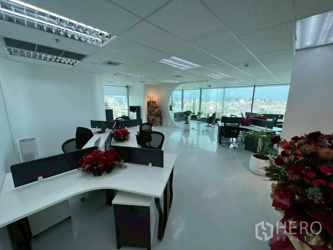 Office Space for rent in Din Daeng, Bangkok - Bright open-plan office with shared workstations, large windows, and skyline views.