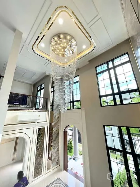 Detached House for sale in Thawi Watthana, Bangkok - Grand double-height foyer with floor-to-ceiling windows and crystal chandelier