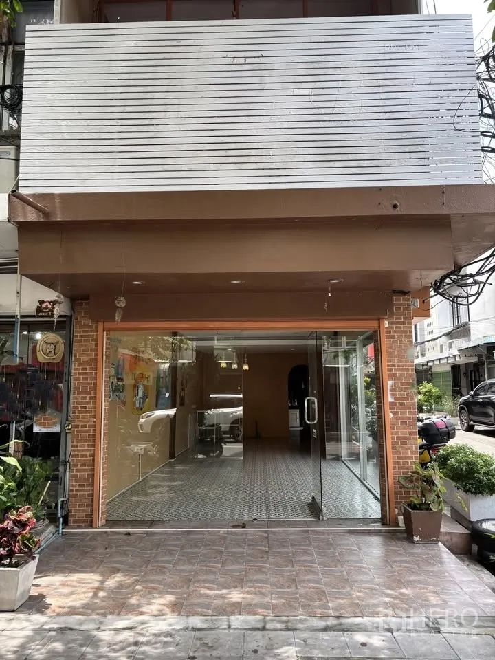 Retail Space for rent in Sathon, Bangkok - Close view of the glass storefront with brick trim and a large signboard above.