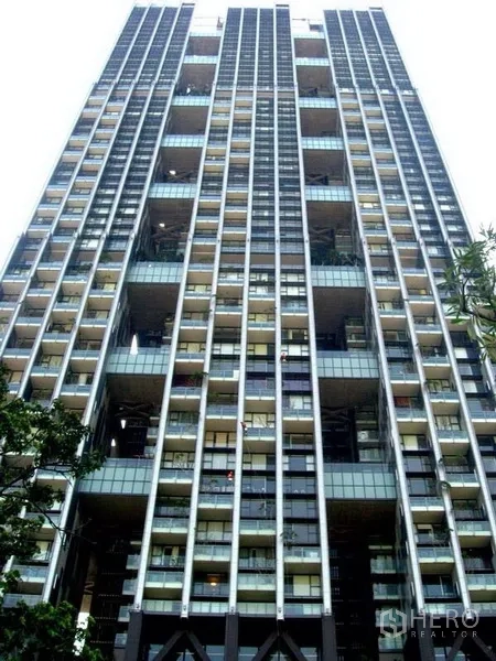 Condominium for rent in Sathon, Bangkok - High-rise condominium exterior with stacked balconies and a glass facade in Sathon.