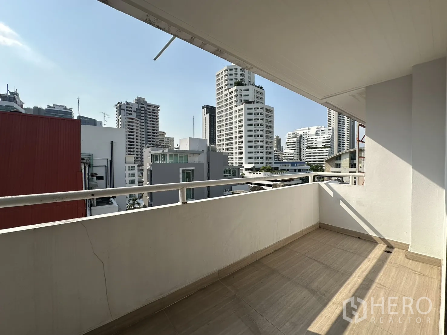 Condominium for rent in Watthana, Bangkok - Private balcony with tiled floor and urban skyline view.