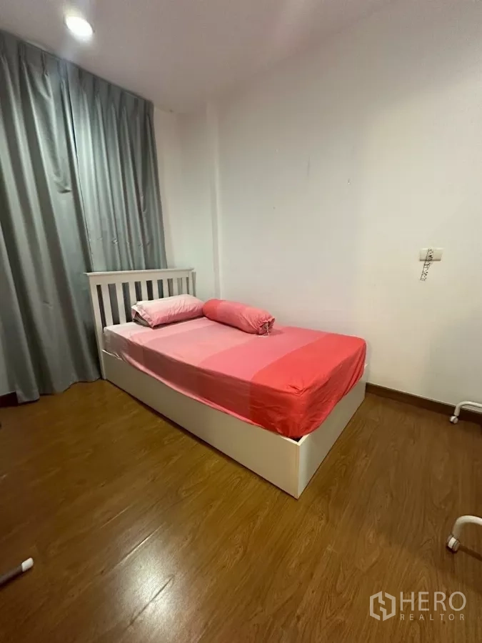 Townhouse for rent in Chom Thong, Bangkok - Cozy single bedroom with pink bedding and grey curtains.
