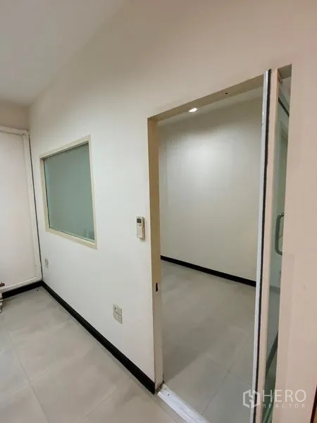 Office Space for rent in Watthana, Bangkok - Compact meeting room with sliding glass door and internal window in a white office.