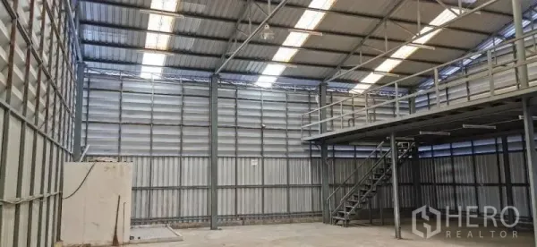 Warehouse for rent in Huai Khwang, Bangkok - Warehouse hall with skylight roof panels, ventilation louvers, and mezzanine storage.