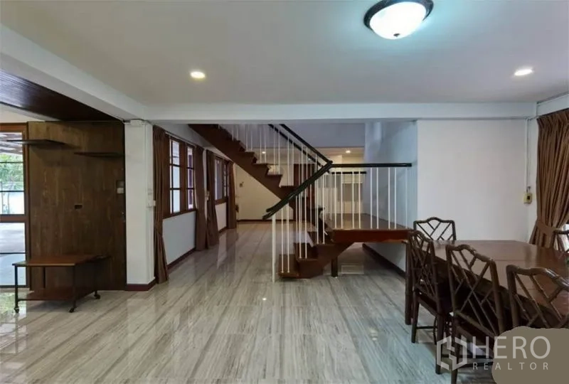 独立式住宅 出租在Watthana, Bangkok - 开放式客餐厅，亮面地砖与木楼梯