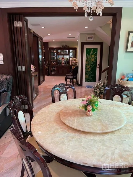Detached House for sale in Bueng Kum, Bangkok - Elegant dining area with round marble table, chandelier, and wood cabinetry in a Bangkok detached house.