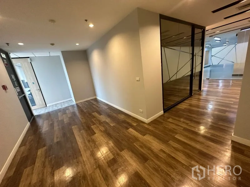 Office Space for rent - Entrance corridor with glass partitions and frosted design panels opening to an office area.