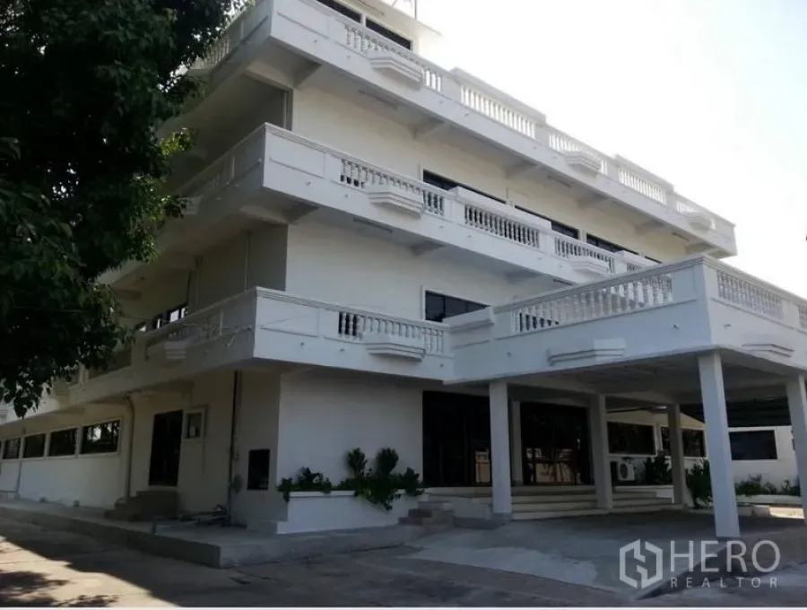 Office Space for rent - Front facade of a multi-level office with wraparound balconies and driveway parking.
