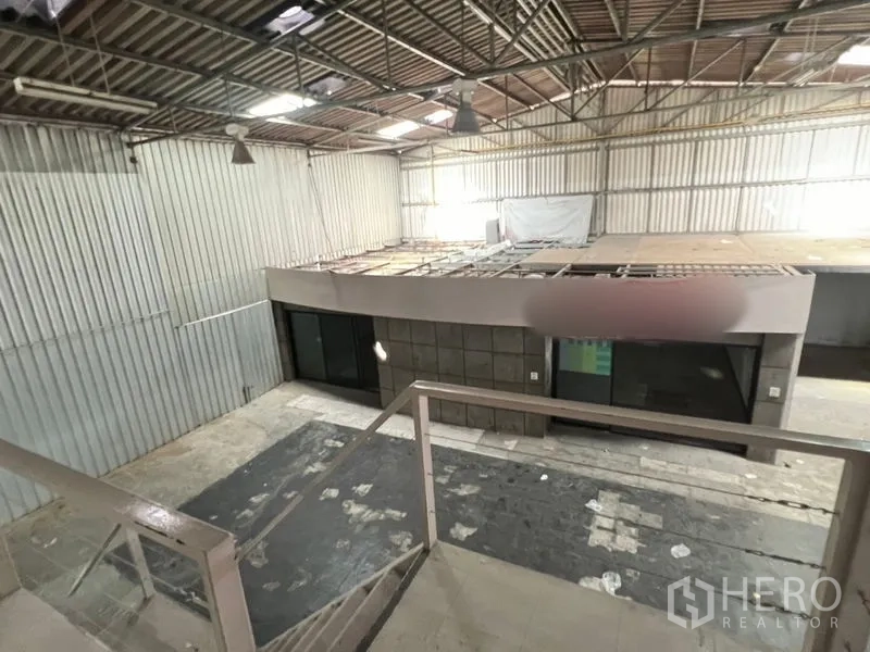Warehouse for rent in Suan Luang, Bangkok - View from mezzanine staircase across the warehouse roof and open floor.