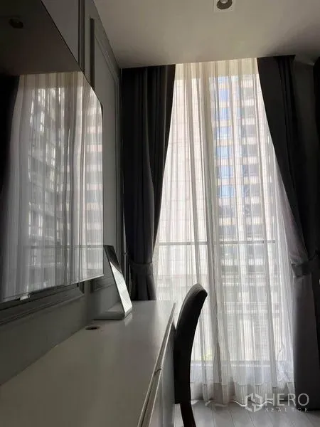 คอนโด ให้เช่าในPathum Wan, Bangkok - มุมทำงานติดหน้าต่างสูงจรดเพดาน พร้อมผ้าม่านโปร่งและทึบ เห็นวิวเมือง