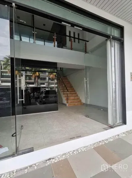 Home Office for rent in Prawet, Bangkok - Ground-floor glass entrance with wide display windows and wood staircase