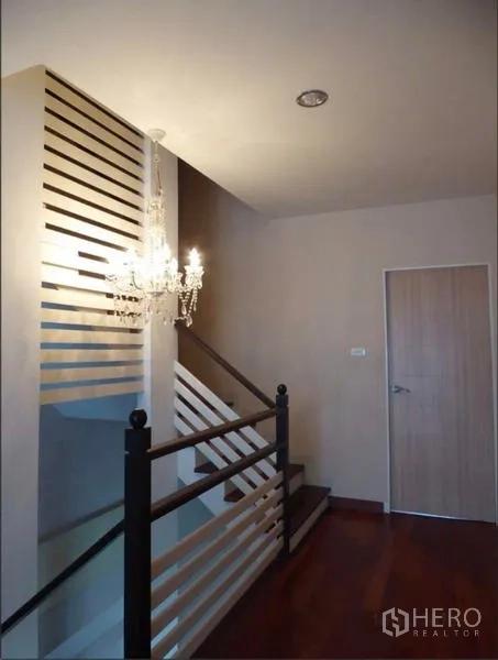 Home Office for rent in Bueng Kum, Bangkok - Staircase with decorative slatted partition and crystal chandelier.