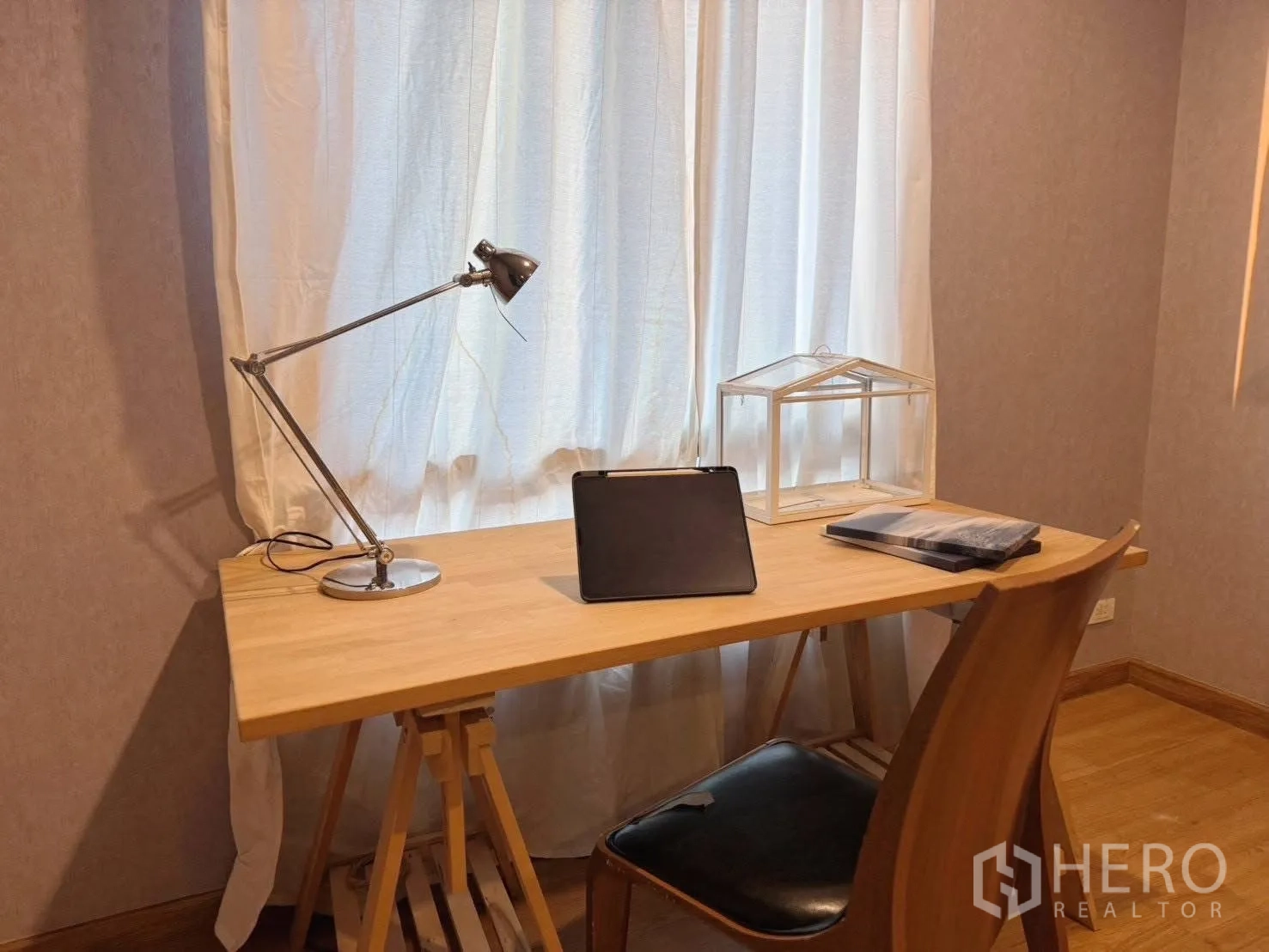 Detached House for rent or sale in Suan Luang, Bangkok - Compact study with wooden desk, lamp and chair by curtained window.