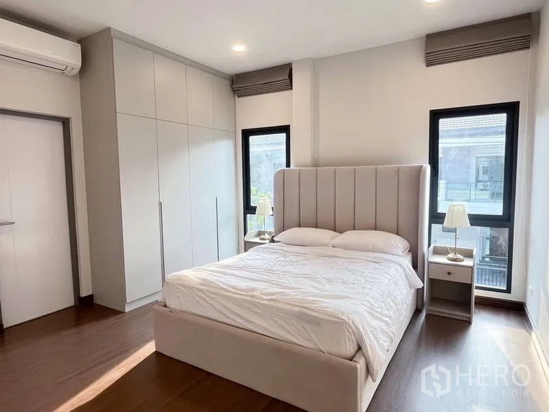 Detached House for rent or sale in Bang Phli, Samut Prakan - Bright bedroom with fitted wardrobes and large windows.