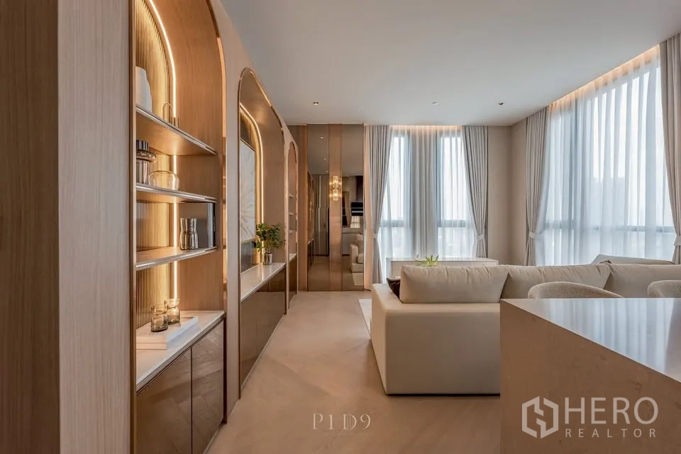 คอนโด for rent in Sathon, Bangkok - โถงทางเดินที่มีตู้ชั้นโค้งไฟซ่อนต่อเนื่องสู่พื้นที่นั่งเล่นสว่าง