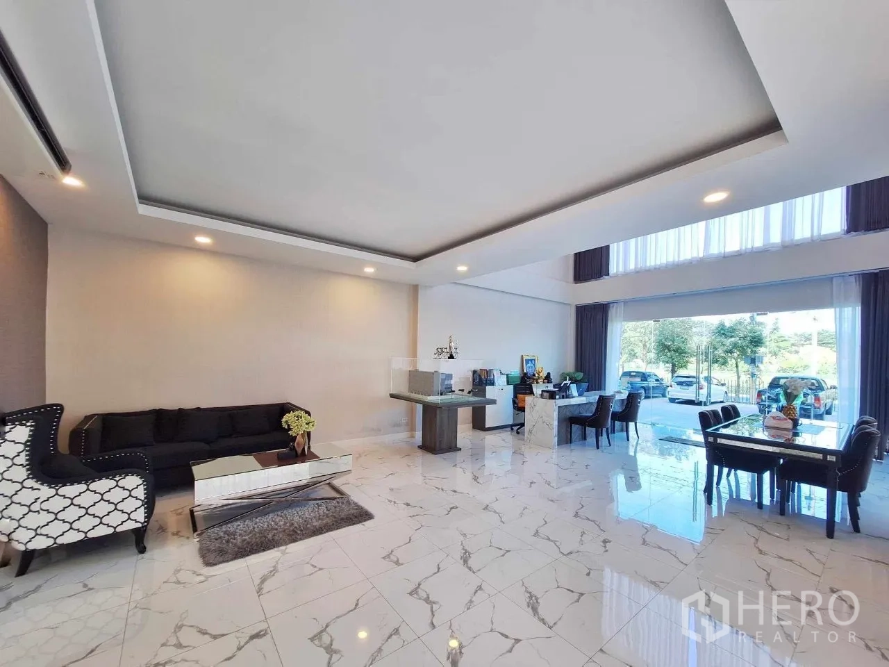 Home Office for sale in Bueng Kum, Bangkok - Open-plan ground floor workspace with recessed lighting, sofa lounge and glossy marble flooring.