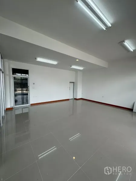 Warehouse for rent in Bang Khun Thian, Bangkok - Bright ground-floor office with wide glass frontage and tiled flooring.