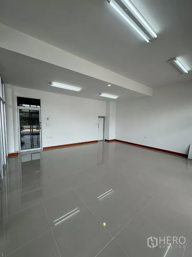 Warehouse for rent in Bang Khun Thian, Bangkok - Bright ground-floor office with wide glass frontage and tiled flooring.